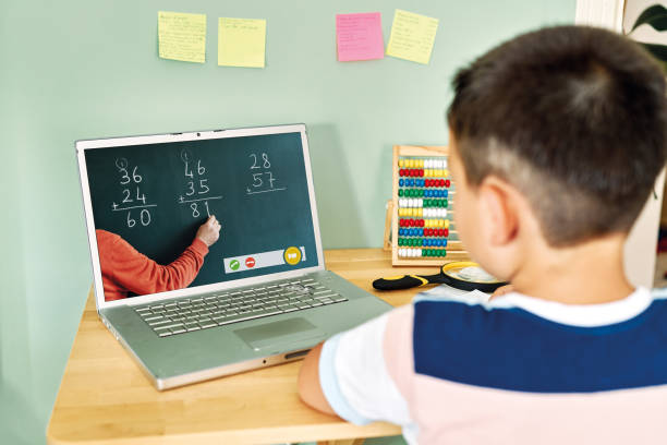 istock 6-7 years cute child learning mathematics from computer. Homeschooling 1255417061