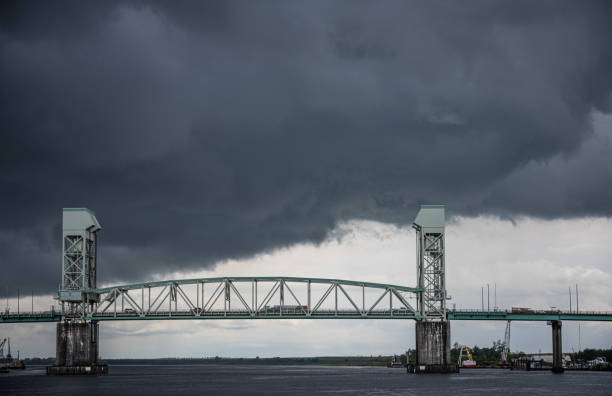 A look at the Cape Fear Memorial Bridge, set against a dramatic storm cloud, in downtown Wilmington, NC, USA.