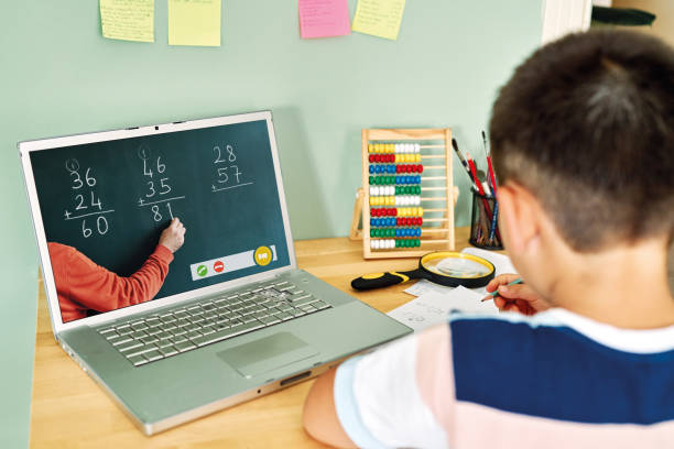istock 6-7 years cute child learning mathematics from computer. Homeschooling 1255417352
