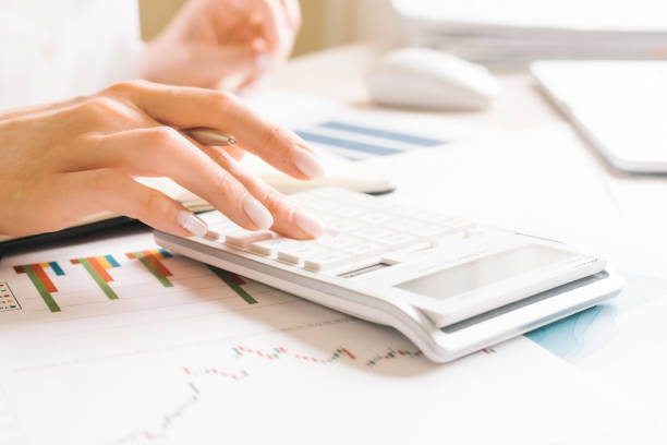 istock worker using calculator with computer laptop, budget and loan paper in office. 1255417907