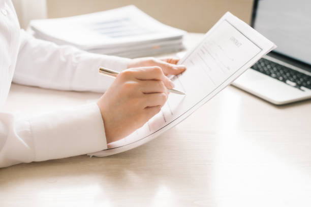 istock reads a contract and holds a metal pen 1255417922