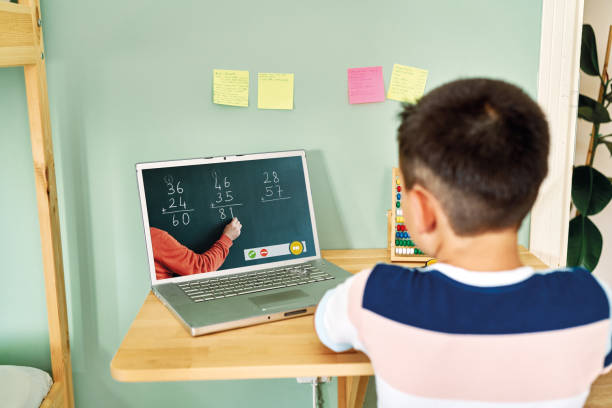 istock 6-7 years cute child learning mathematics from computer. Homeschooling 1255417985