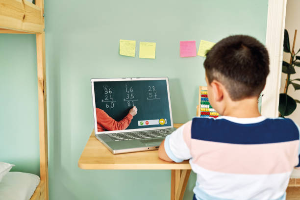 istock 6-7 years cute child learning mathematics from computer. Homeschooling 1255418645