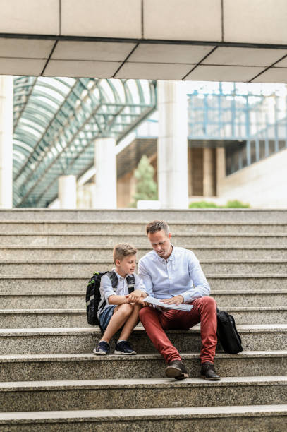 istock Father and son reading a book together. 1255418663