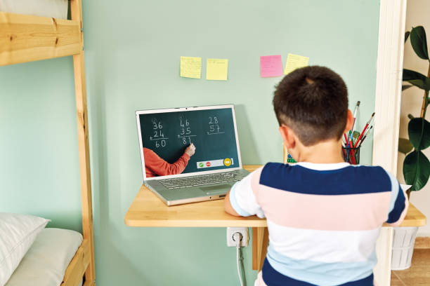 istock 6-7 years cute child learning mathematics from computer. Homeschooling 1255418693
