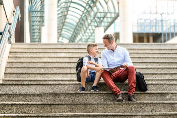 istock Happy father and son reading a book together. 1255419516