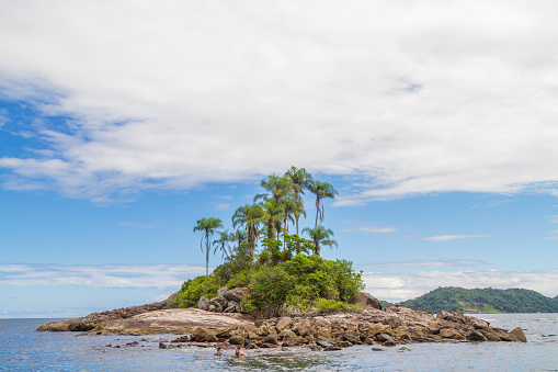 March 5, 2020 - Ilha Grande, Rio de Janeiro, Brazil: A couple of tourists snorkeling and enjoying an idyllic beautiful tropical adventure turquoise island landscape with tropical trees inside Atlantic ocean in a hot sunny summer day in Ilha Grande, Angra do Reis, Rio de Janeiro, Brazil.