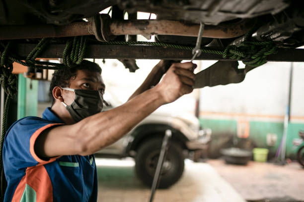 istock Technician automotive checking car in the garage 1255420917