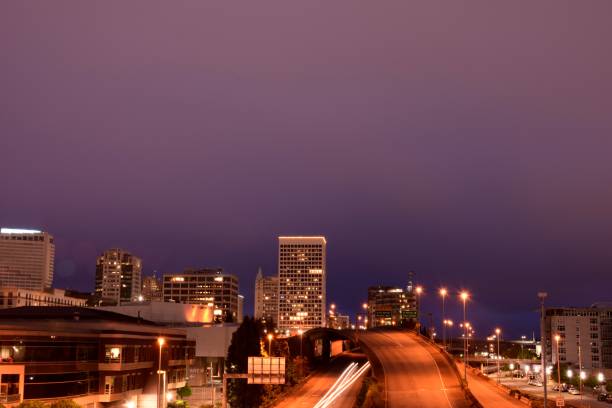 istock Modern Highway Through Cityscape Against Night Sky 1255422941