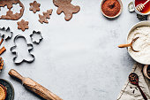 Baking gingerbread man Christmas cookies in kitchen