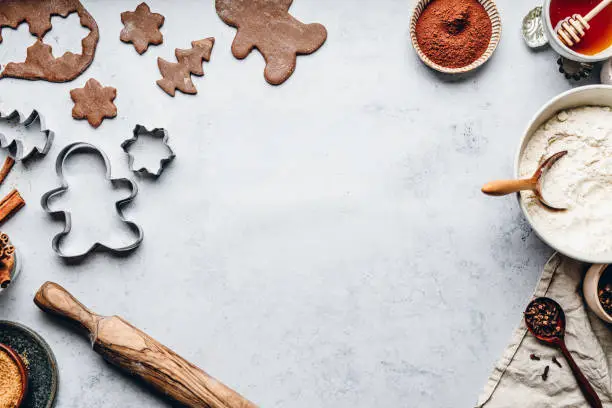 Photo of Baking gingerbread man Christmas cookies in kitchen