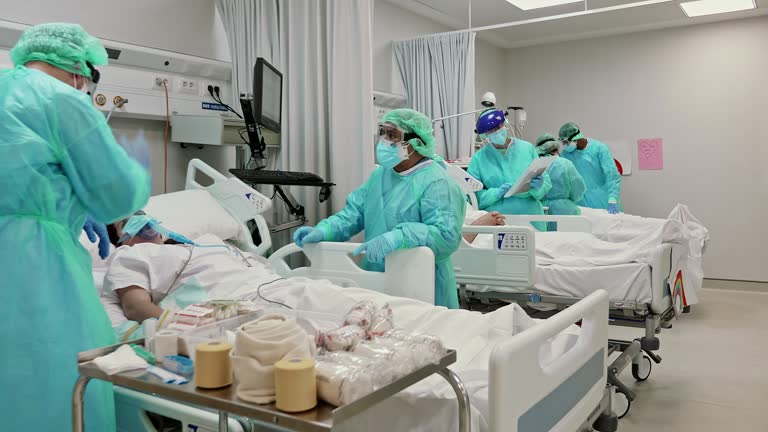 Slow motion video of frontline doctors and nurses taking care of patients in ICU during the pandemic of COVID-19.