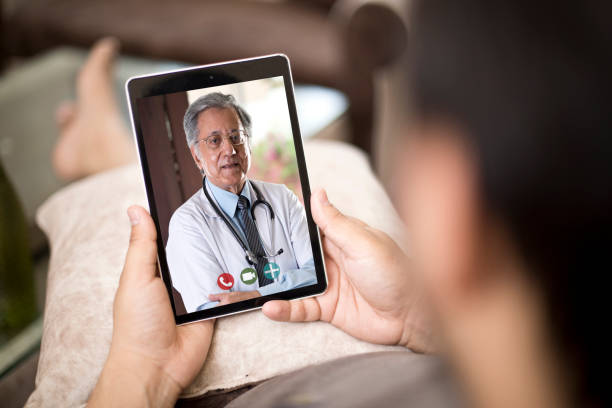 istock Man in video conference with doctor 1255427118
