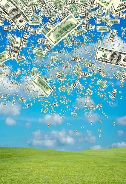 istock falling money over green landscape 125542817