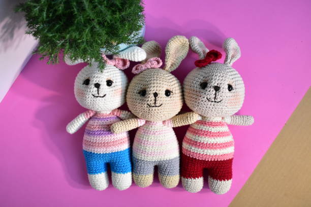 istock Cute crochet bunny, pink pastel background, top view, flat lay, handmade rabbit, top view, flay lay, pine tree, Christmas bunny, Easter rabbits, Thanksgiving, gift, childhood, toy kids 1255430021