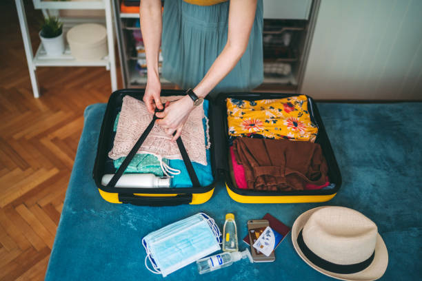 istock Suitcase packing for travel, COVID-19 concept 1255431669