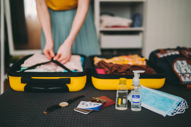 istock Suitcase packing for travel, COVID-19 1255431737
