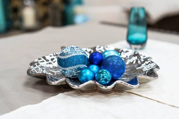 Beautiful still life with round blue christmas decorations. New year decorations on silver plate indoor. Shining blue balls on table. Christmas still life. Close up shot Beautiful still life with round blue christmas decorations. New year decorations on silver plate indoor. Shining blue balls on table. Christmas still life. Close up shot. silver platter stock pictures, royalty-free photos & images