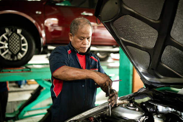 istock Auto mechanic working in garage. Repair service. 1255433339