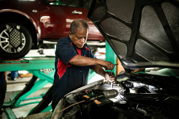 istock Auto mechanic working in garage. Repair service. 1255434104