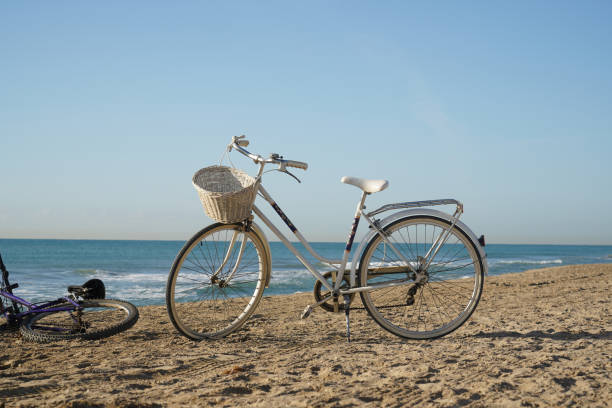 istock white old bicycle on the beach, Spain 1255434297