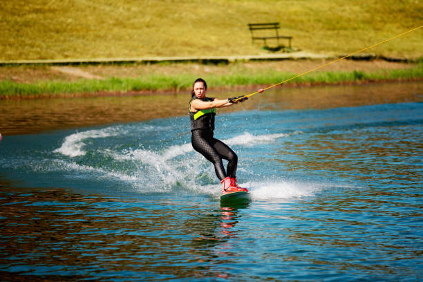 istock Making a turn riding wakeboard on the lake 1255434505