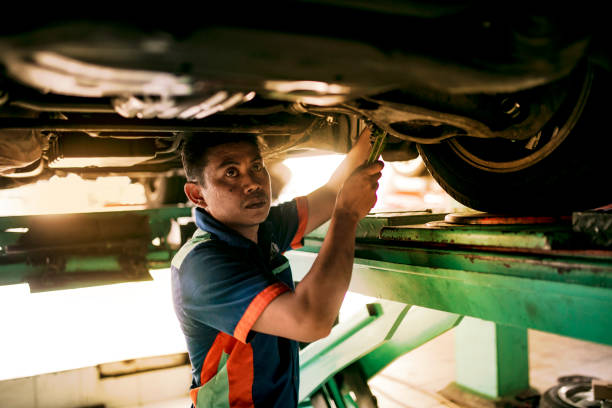 istock Technician automotive checking car in the garage 1255435338