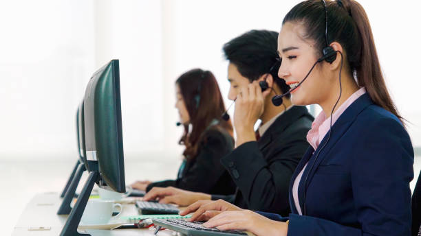 istock Business people wearing headset working in office 1255437268