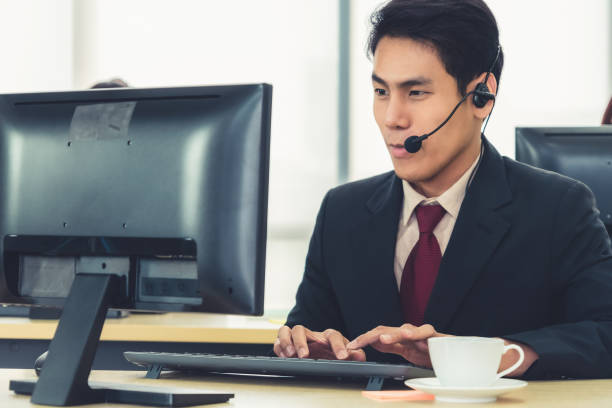 istock Business people wearing headset working in office 1255438478