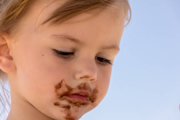 istock little girl eating ice cream 1255438819
