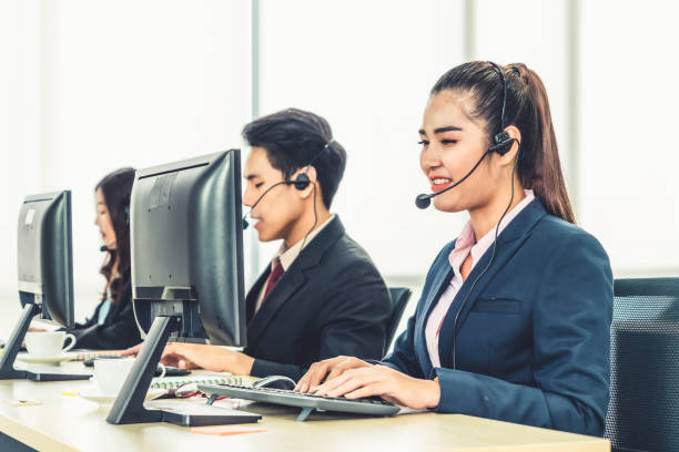 istock Business people wearing headset working in office 1255440176