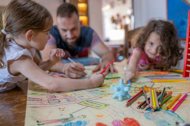 istock Sisters and their father drawing coronavirus at home 1255441471