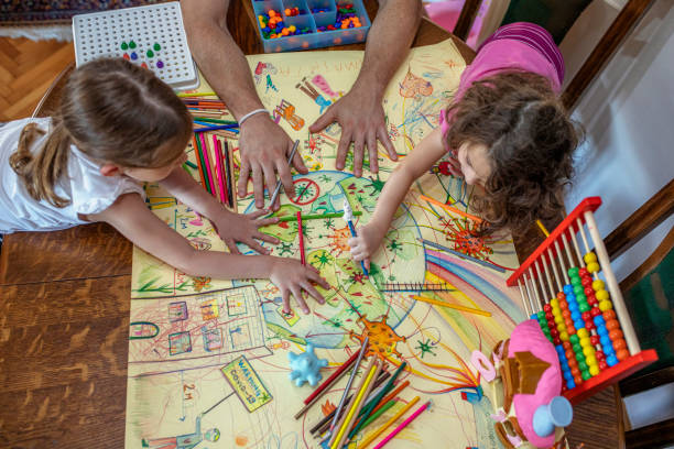istock Sisters and their father drawing coronavirus at home 1255441597
