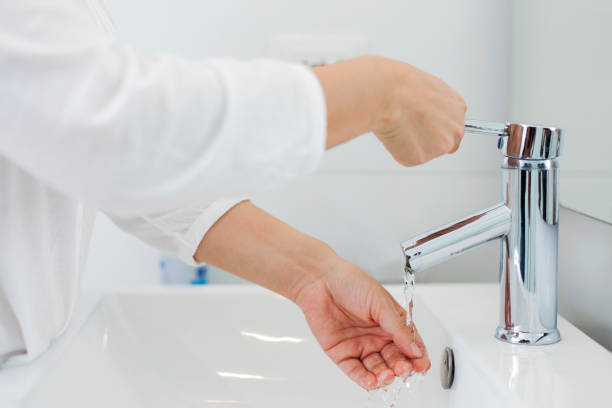 istock Unrecognizable person washing her hands 1255442401