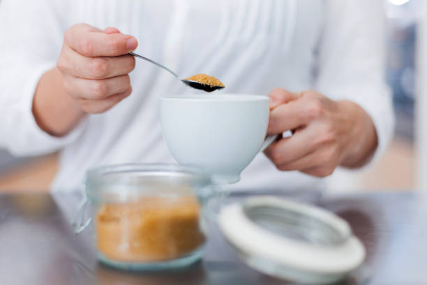 Cubes of cane brown sugar in ceramic cup