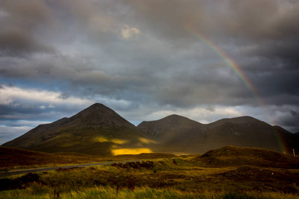 Rainbow over Scottish mountains stock photo