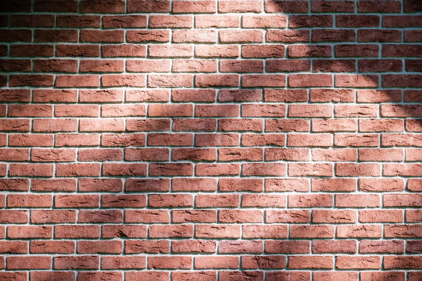 istock Red illuminated brick wall with lines and textures on the surface 1255444524