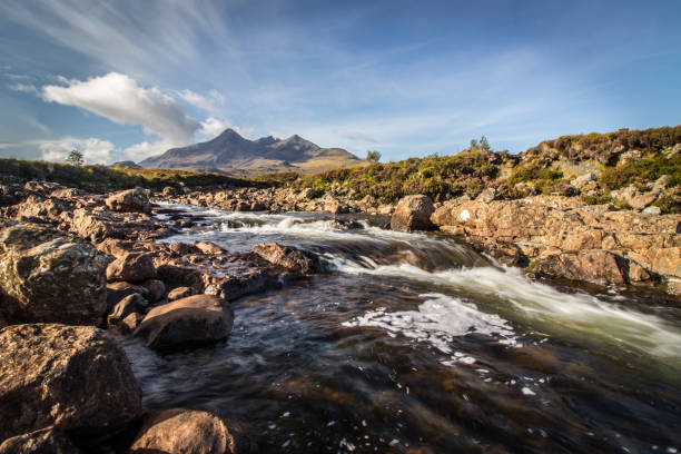 A small river with the Black Cuillin mountain in the background stock photo