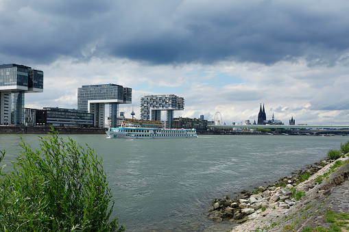 View from the riverside in Poll towards the Rheinauhafen and the Cologne Cathedral.