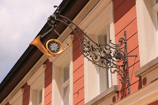 Passau, June 30, 2020: Replica of an old post horn on a historic building in the old town of Passau in Bavaria