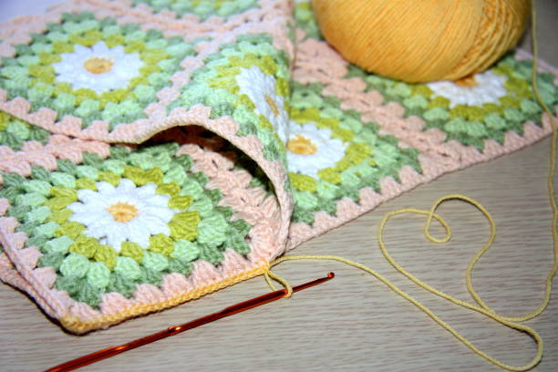 istock Beautiful knitted napkin with a camomile floral pattern. 1255450953