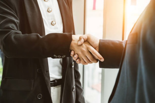 istock Business people handshake in corporate office 1255452176