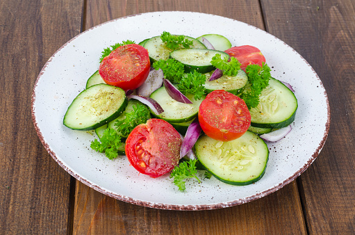 Chopped fresh vegetables on white plate.