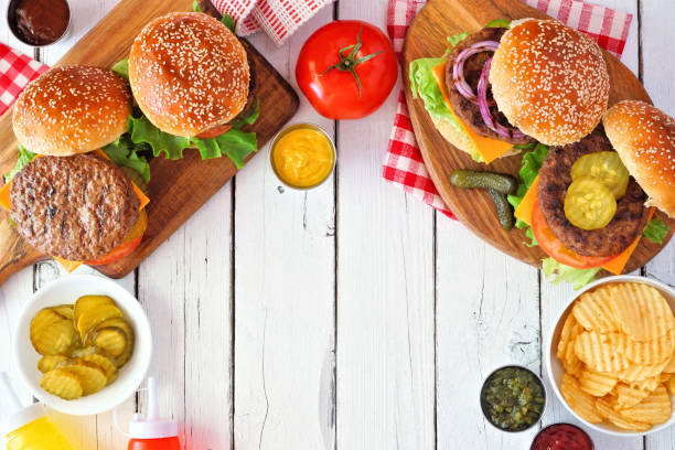 istock BBQ hamburger frame, top view table scene over a white wood background 1255455852