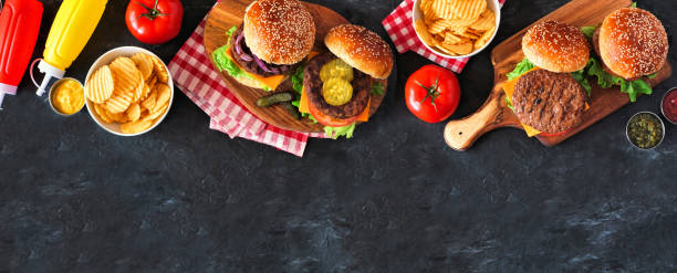 istock BBQ hamburger top border, overhead view table scene on a slate background 1255456085