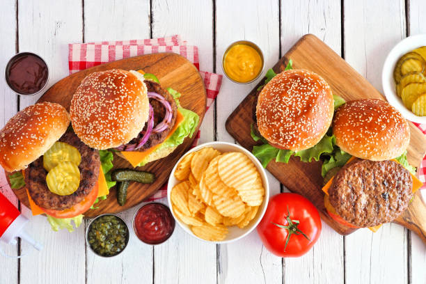 istock BBQ hamburger table scene, above view over white wood 1255456307