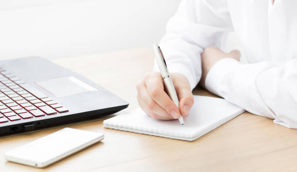 istock A girl sits at an office desk with a laptop. Working space 1255458859