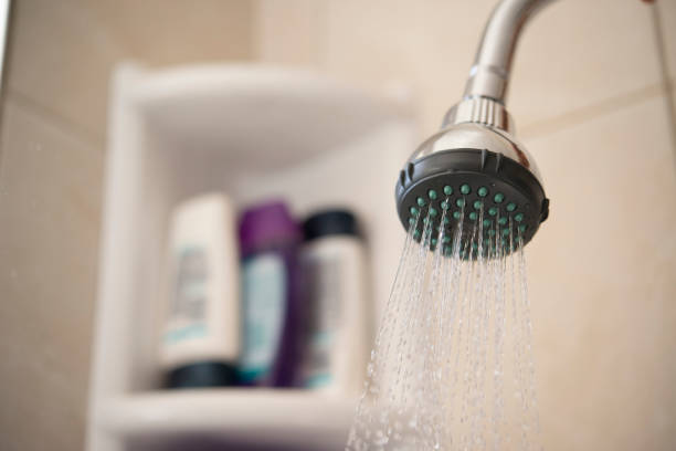 Use of water. Bathroom shower being used. Water must be used consciously, avoiding waste and preserving natural resources. shower head stock pictures, royalty-free photos & images