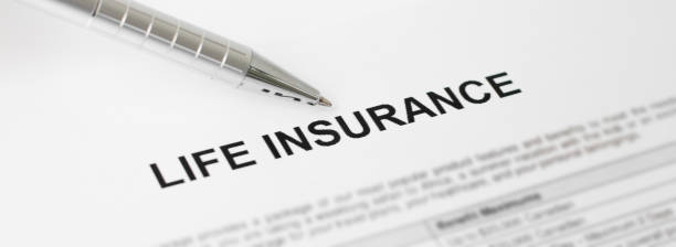life insurance document with pen nearby - clause imagens e fotografias de stock