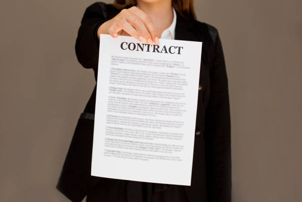 istock Young business woman showing contract 1255459317